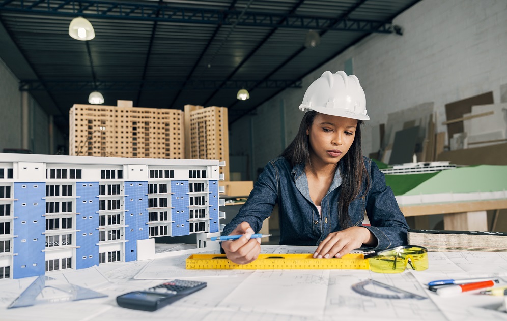 african-american-woman-safety-helmet-working-near-model-building