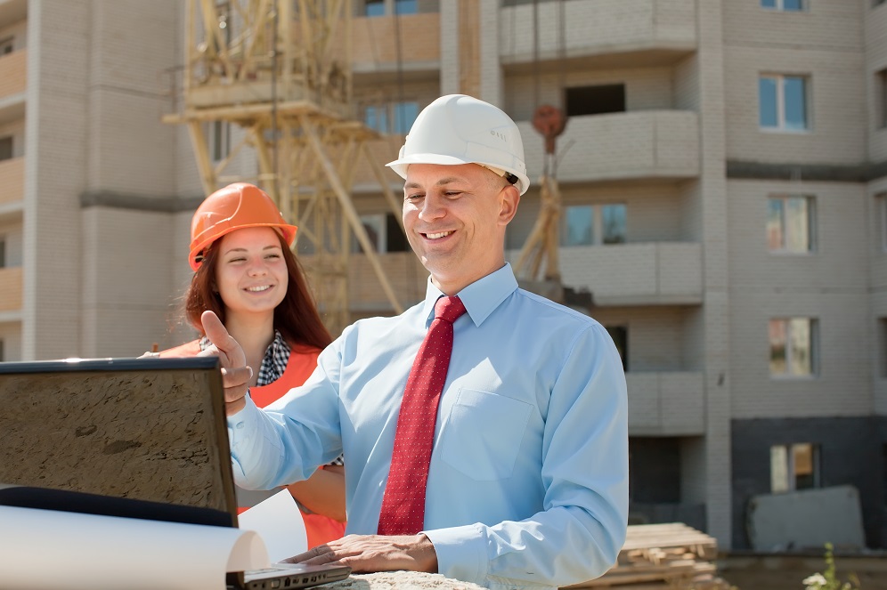 White-collar workers wearing protective helmet works on the building site